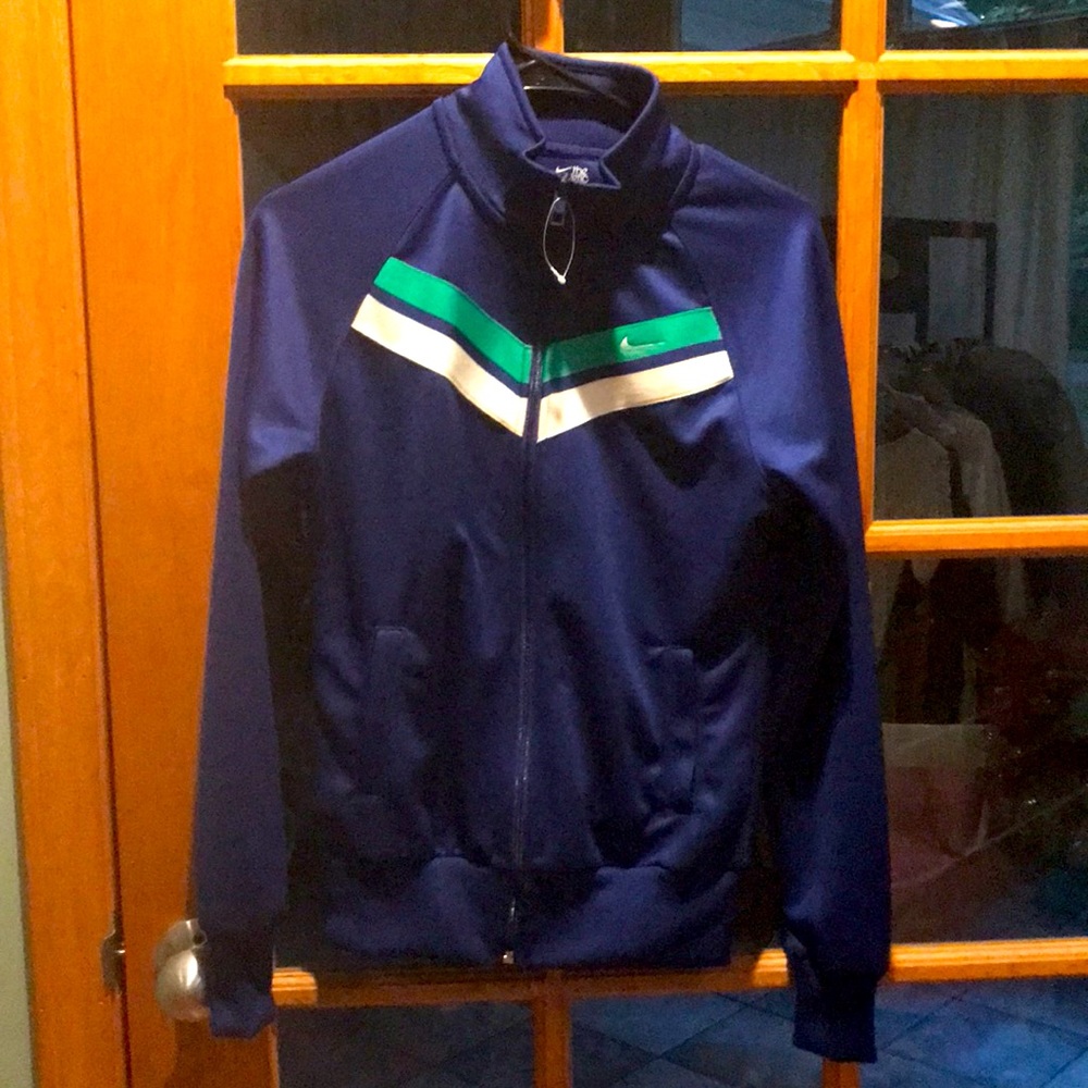 Nike women’s track jacket. Size S. Elastic cuffs and hips. Zipper front. Royal.